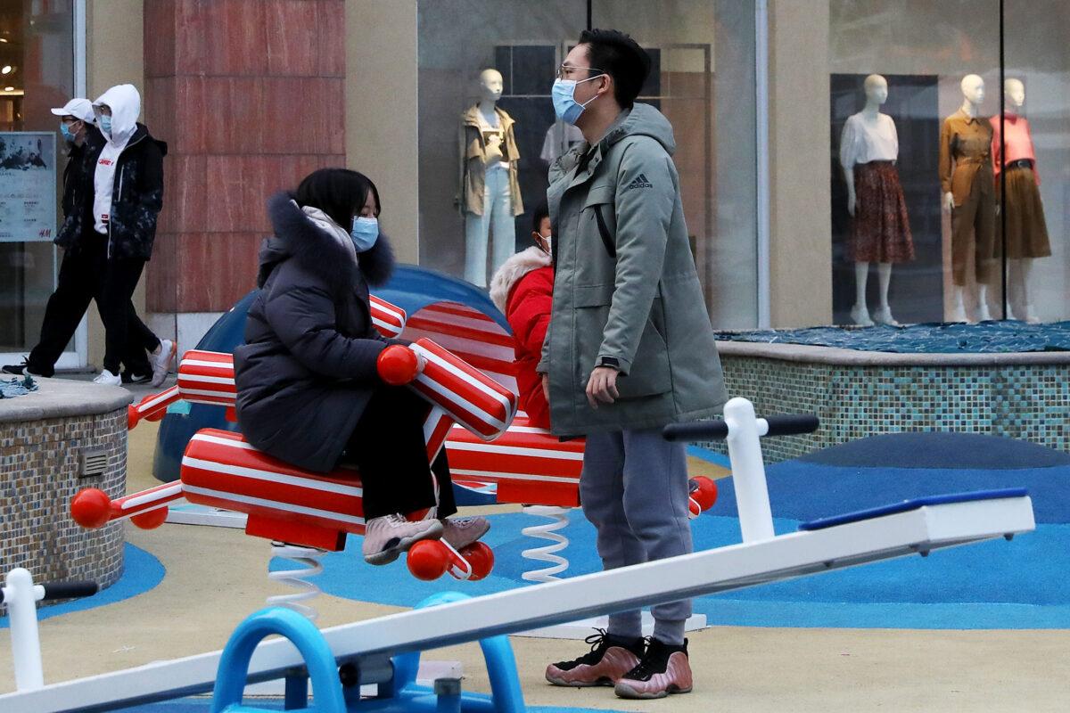 Chinese people wear protective masks as they briefly play at a shopping mall in Beijing, China on Feb. 18, 2020. (Lintao Zhang/Getty Images)