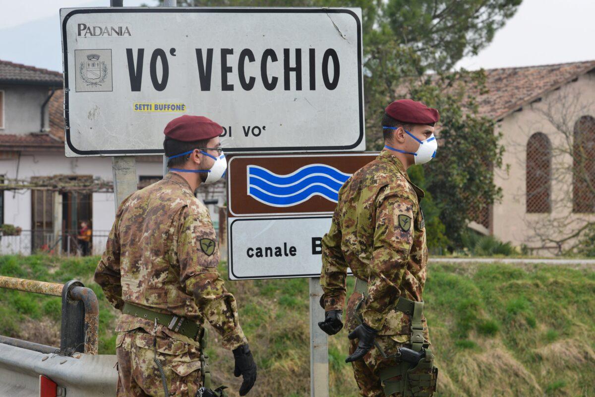 Italian soldiers patrol by a check-point at the entrance of the small town of Vo Vecchio, situated in the red zone of the COVID-19 the novel coronavirus outbreak, northern Italy, on Feb. 24, 2020. (Marco Sabadin/AFP via Getty Images)