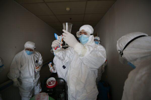 Workers prepare to disinfect rooms at the Red Cross hospital in Wuhan, Hubei Province, China, on March 18, 2020. (STR/AFP via Getty Images)