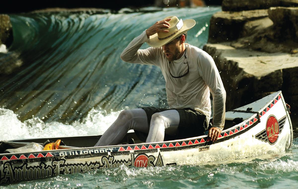 A canoe race participant collects himself after running one of the few "rapids" of the San Marcos River. (Courtesy of Greater San Marcos Partnership Library)