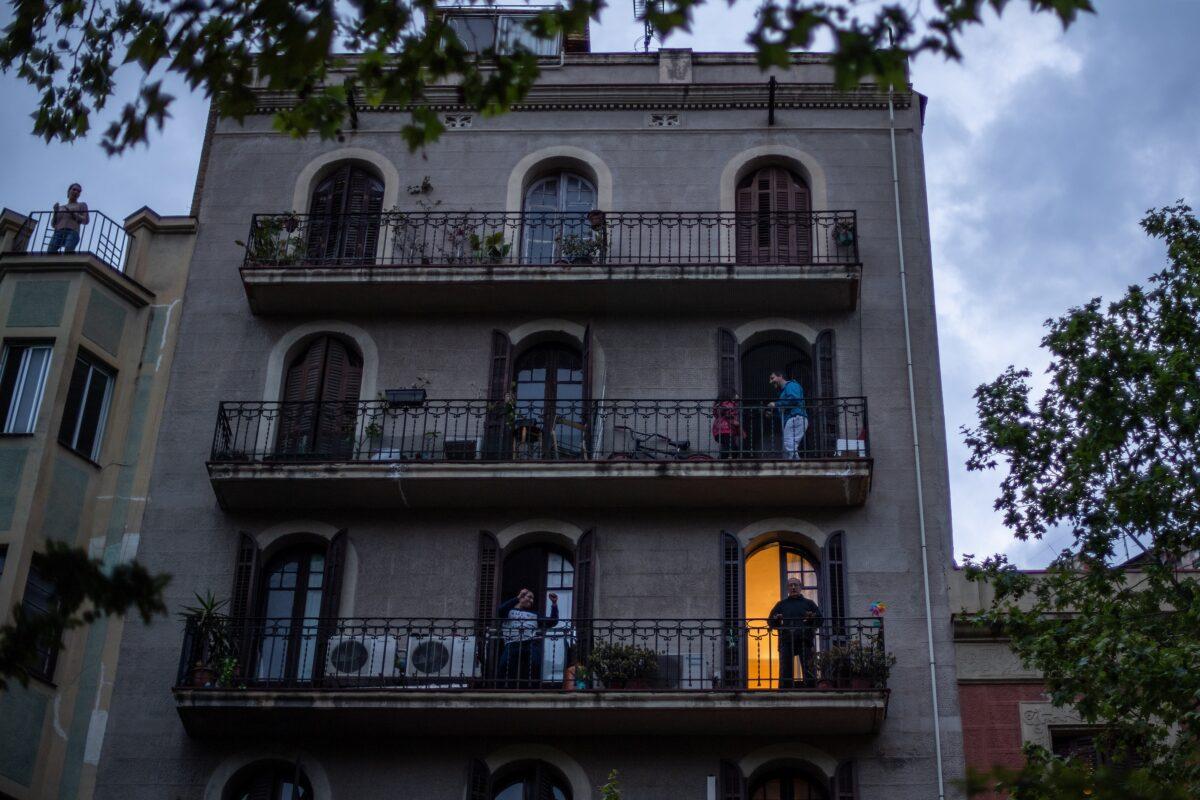 People dance on their balconies while listening to a neighbor playing music in Barcelona, Spain, on April 8, 2020. (David Ramos/Getty Images)