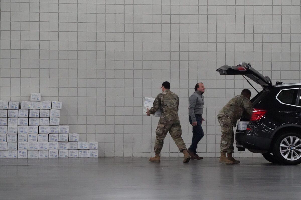 U.S. Army National Guard members unload boxes at the Jacob Javits Center on Manhattan’s West Side after New York Gov. Andrew Cuomo announced that he is converting the center into a field hospital, in New York on March 23, 2020. (Bryan R. Smith/AFP/Getty Images)