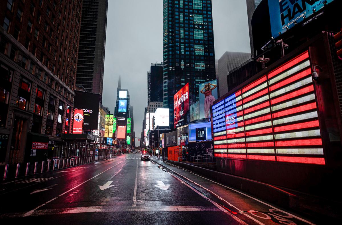 The American Flag illuminates a street in Times Square amid the COVID-19 pandemic in New York, N.Y., on April 30, 2020. (Johannes Eisele/AFP via Getty Images)