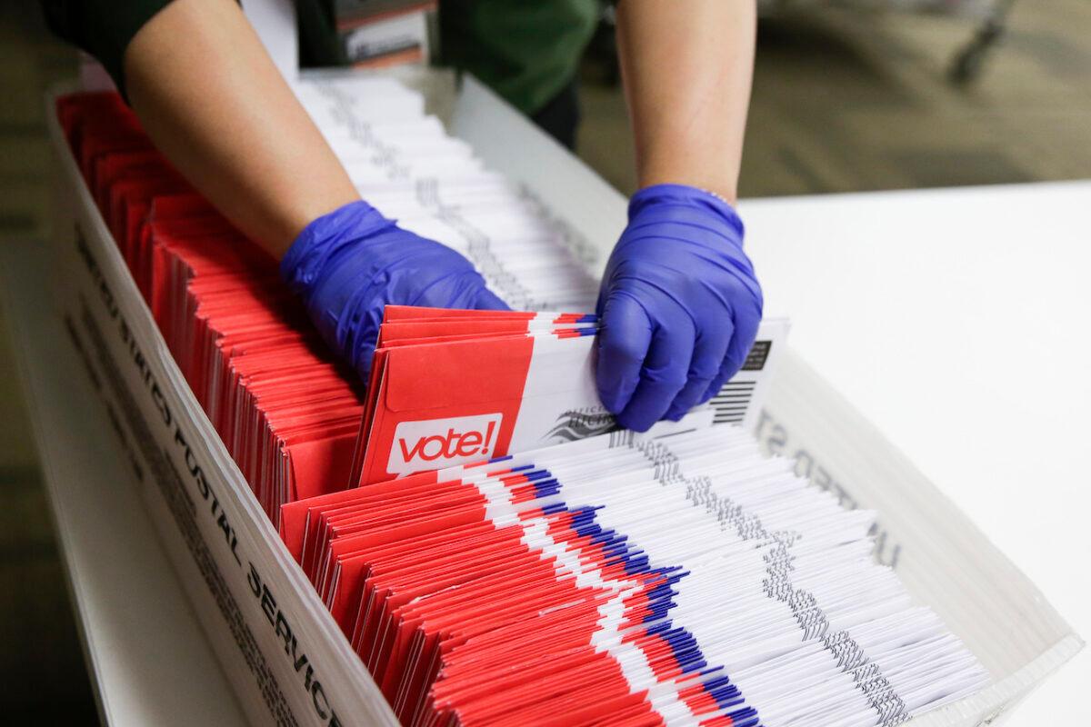 Election workers sort vote-by-mail ballots for the presidential primary at King County Elections in Renton, Washington state, on March 10, 2020. (Jason Redmond/AFP via Getty Images)