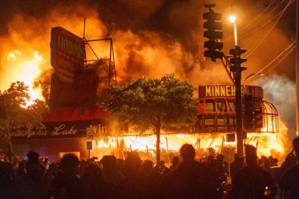 Protesters gather in front of a burning liquor store near the Minneapolis Police 3rd Precinct in Minneapolis, Minn., on May 28, 2020. (Kerem Yucel/AFP via Getty Images)