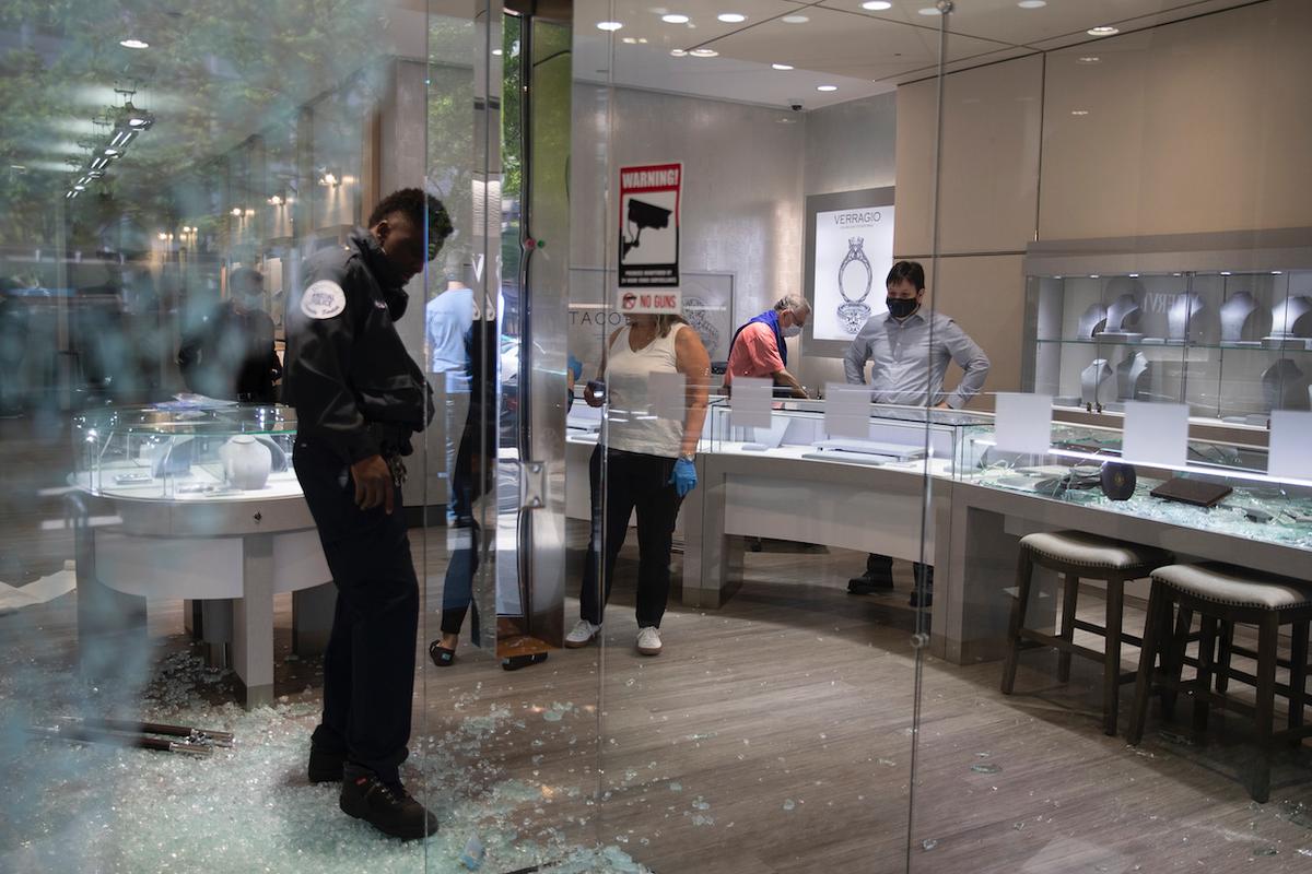 Shattered window and door glass is scattered on the floor inside Mervis Diamond Importers after a night of protests over the death of George Floyd in Washington on June 1, 2020. (Carolyn Kaster/AP Photo)