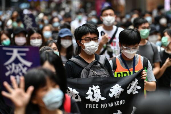 Protesters march on a road during a pro-democracy rally against a proposed new security law in Hong Kong on May 24, 2020. (Anthony Wallace/AFP/Getty Images)