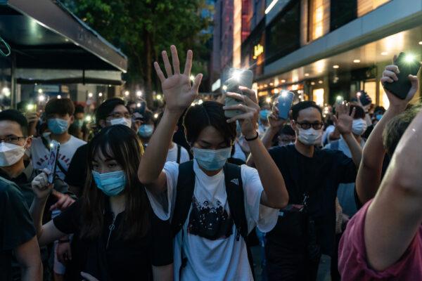 Participants hold up their cellphone's flash lights as they take part in a rally in Central district in Hong Kong, on June 9, 2020. (Anthony Kwan/Getty Images)