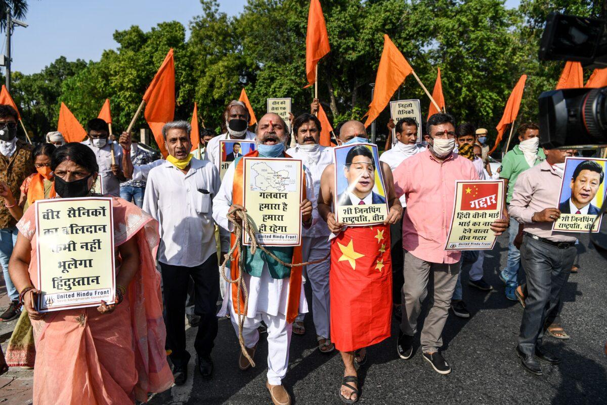 Protesters shout slogans as they hold posters of Chinese President Xi Jinping during an anti-China demonstration near the Chinese embassy in New Delhi, India, on June 18, 2020. (Sajjad Hussain / AFP via Getty Images)