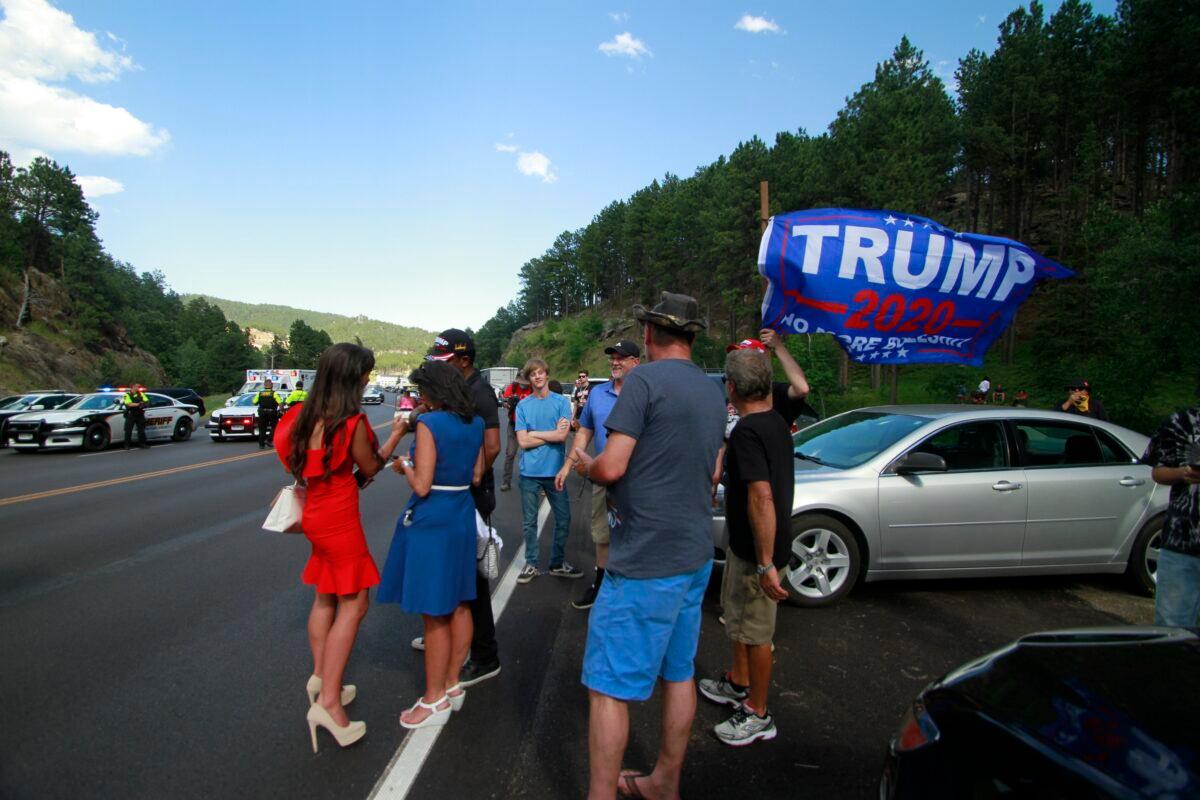 Trump supporters, some who were blocked from reaching Mount Rushmore by a blockade set up by Native American protesters, gather near where protesters clashed with law enforcement officers in Keystone, S.D., on July 3, 2020. (Stephen Groves/AP Photo)