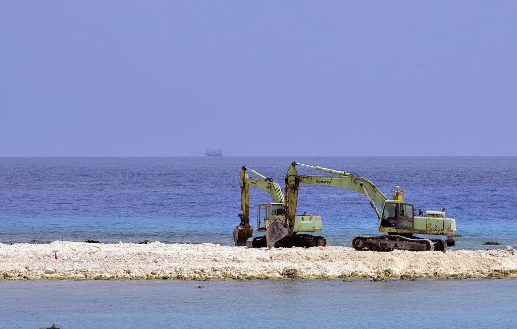 Two excavators are pictured at a construction site on Taiping island in the Spratly chain in the South China Sea on March 23, 2016. (Sam Yeh/AFP via Getty Images)