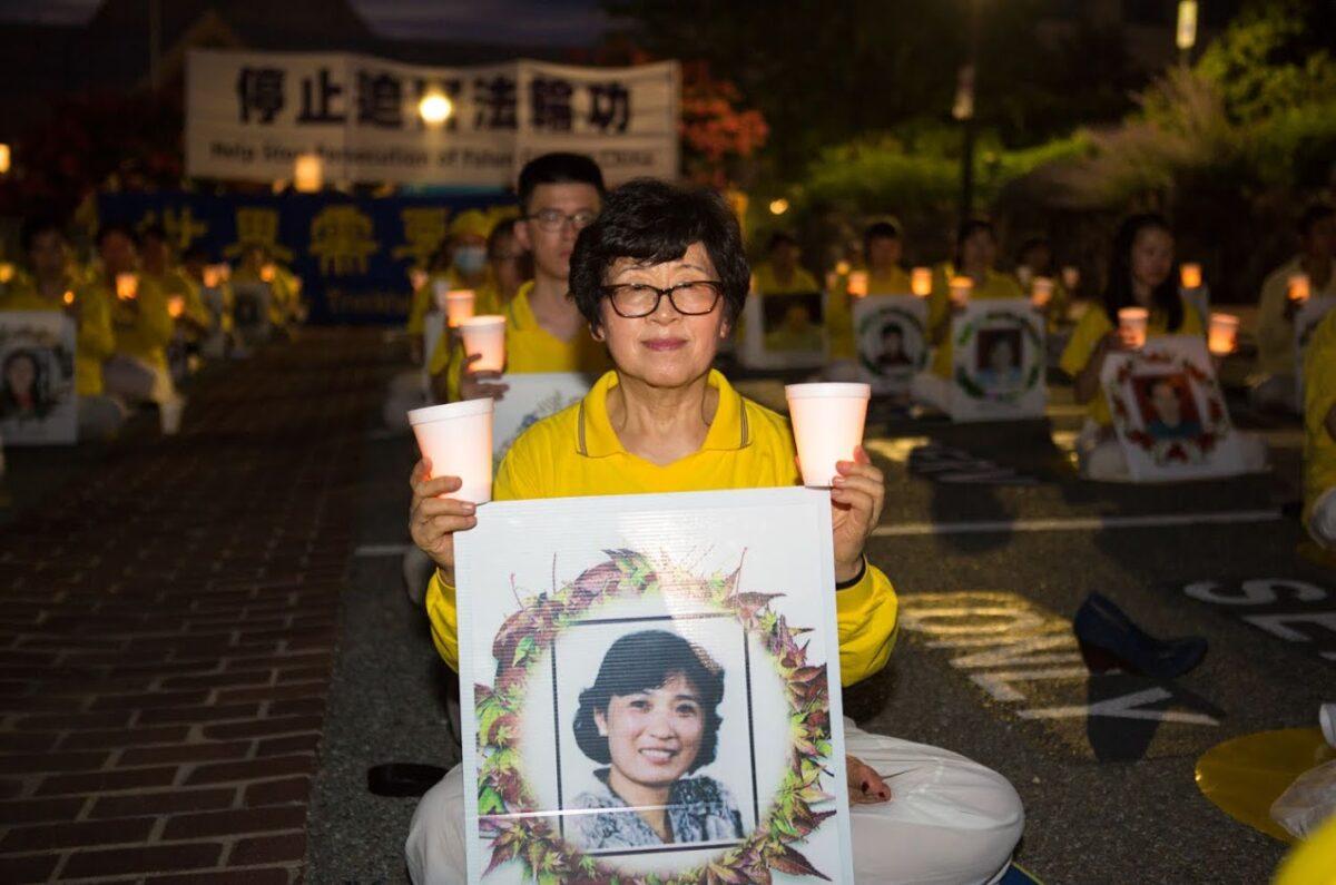 Wang Chunrong participates in a candlelight vigil outside the Chinese Embassy in Washington on July 17, 2020. (Lisa Fan/The Epoch Times)