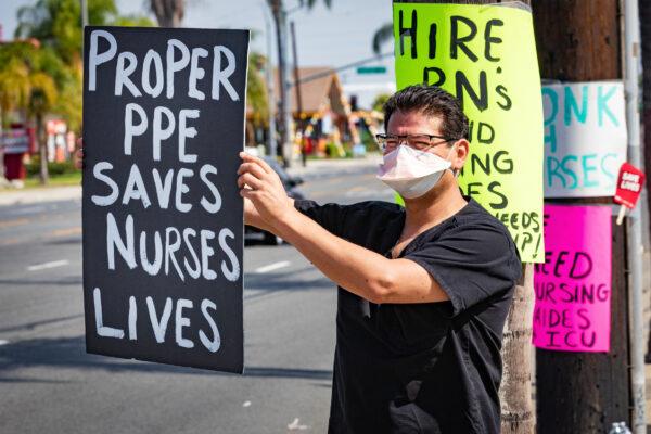 Nurse Wallace Cunningham holds a sign requesting better personal protective equipment (PPE) during a protest outside South Coast Global Media Center in Santa Ana, Calif., on Aug. 5, 2020. (John Fredricks/The Epoch Times)