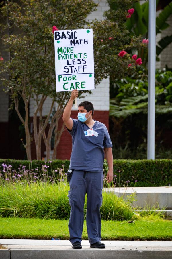 A nurse holds a sign calling for better staffing during a protest outside South Coast Global Medical Center in Santa Ana, Calif., on Aug. 5, 2020. (John Fredricks/The Epoch Times)