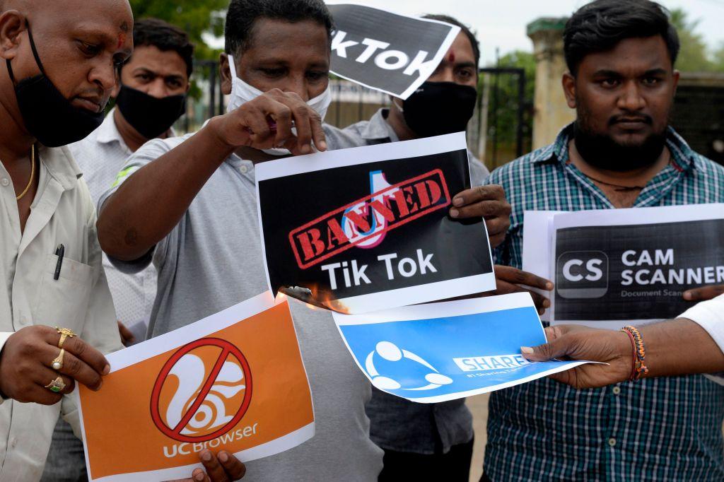 Members of the City Youth Organization hold posters with the logos of Chinese apps in support of the Indian government for banning the wildly popular video-sharing TikTok app, in Hyderabad, India, on June 30, 2020. (Noah Seelam/AFP via Getty Images)