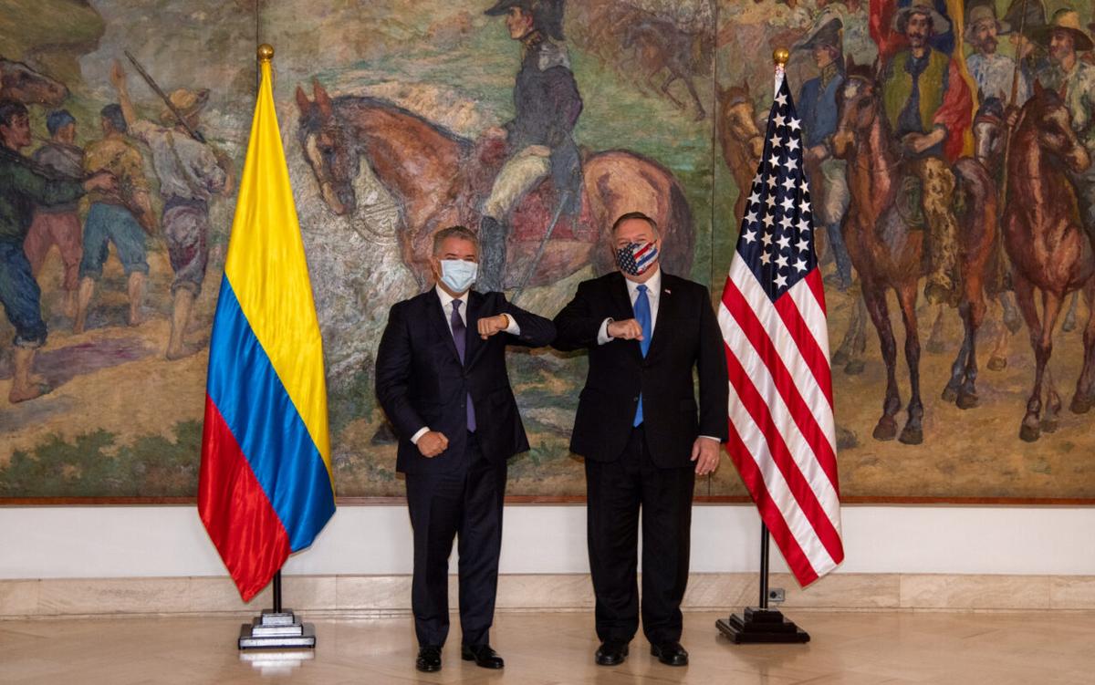 Colombian President Ivan Duque Marquez and U.S. Secretary of State Mike Pompeo bump elbows before attending a meeting at the presidential house in Bogota, Colombia, on Sept. 19, 2020. (Courtesy of Colombian Presidency/Handout via Reuters)