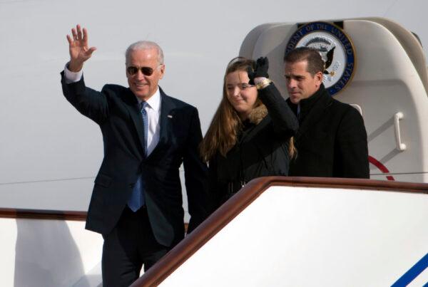 Then-Vice President Joe Biden waves as he walks out of Air Force Two with his granddaughter Finnegan Biden (C) and son Hunter Biden (R) upon their arrival in Beijing on Dec. 4, 2013. (Ng Han Guan/AFP via Getty Images)