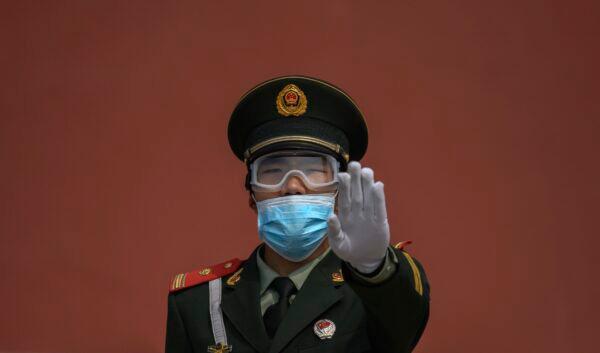 A paramilitary police officer stands guard in Beijing on May 1, 2020.  (Kevin Frayer/Getty Images)
