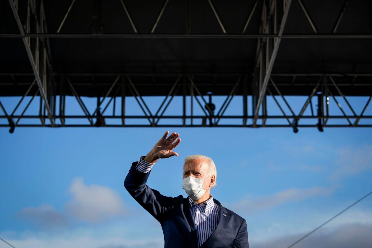 Democratic presidential nominee Joe Biden waves as he arrives onstage for a drive-in campaign rally at Dallas High School in Dallas, Pa., on Oct. 24, 2020. (Drew Angerer/Getty Images)