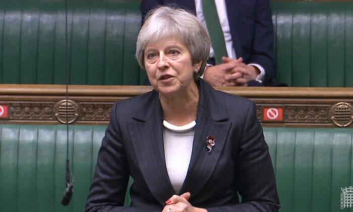 Former Prime Minister Theresa May Urges Johnson to Drop COVID-19 Tests for Travellers
