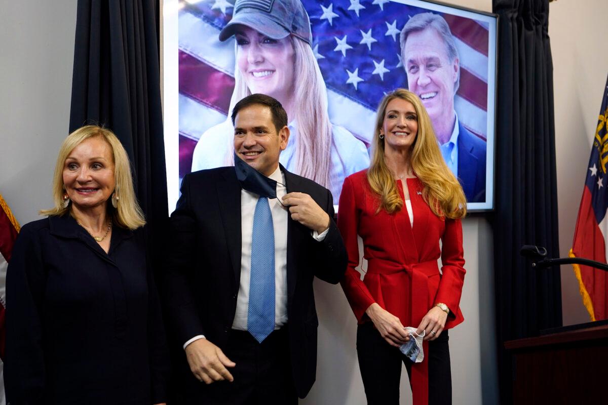 Sen. Marco Rubio (R-Fla.), stands with Georgia Republican candidate for Senate Kelly Loeffler, right, and Bonnie Perdue, wife of Sen. David Perdue (R-Ga.), after a campaign rally Wednesday, Nov. 11, 2020, in Marietta, Ga. (John Bazemore/AP Photo)