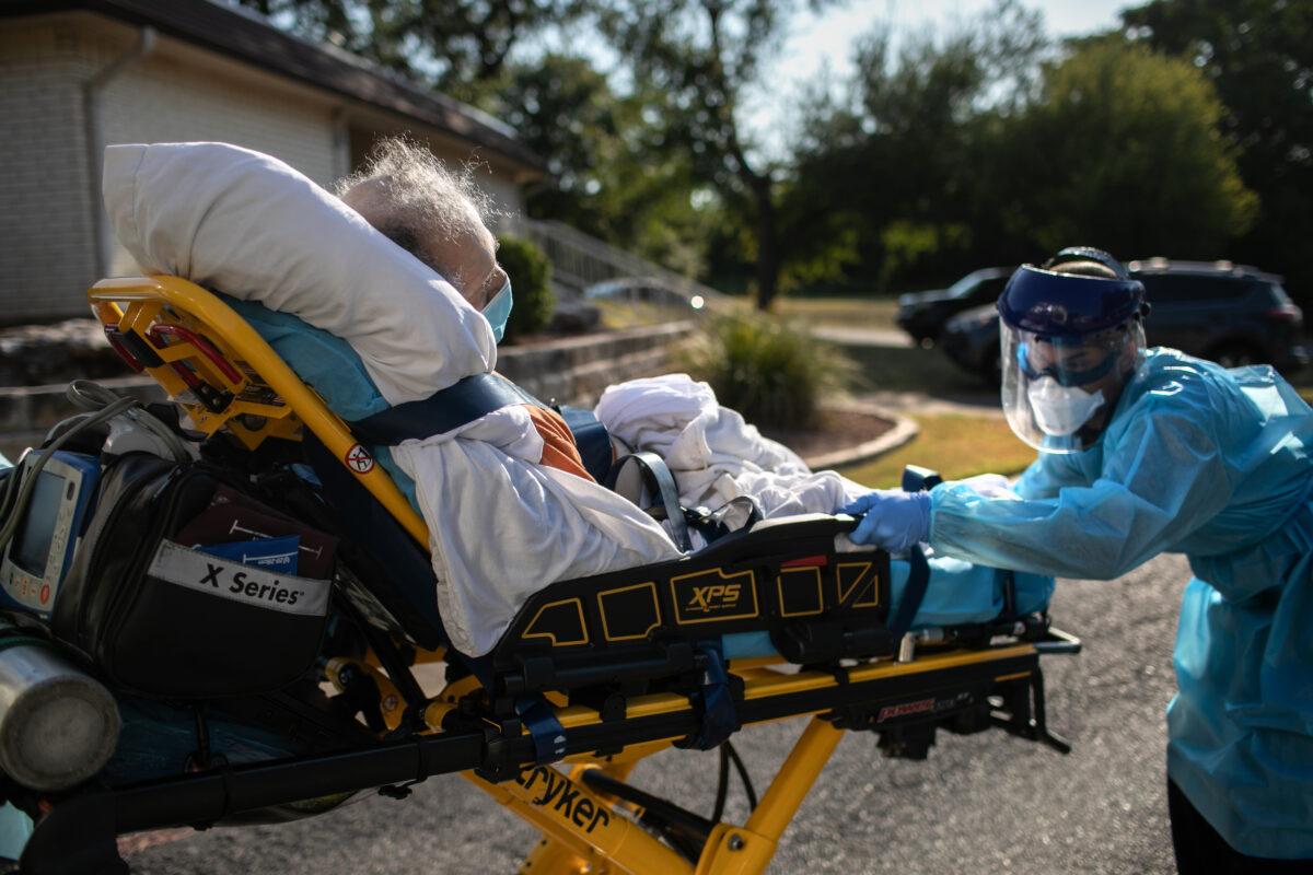 An Austin-Travis County medic loads a patient with COVID-19 symptoms into an ambulance in Austin, Texas, on Aug. 5, 2020. (John Moore/Getty Images)