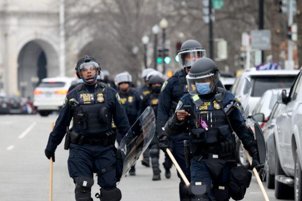 Police officers in riot gear walk toward the U.S. Capitol as a group of protesters breached the Capitol building in Washington on Jan. 6, 2021. (Tasos Katopodis/Getty Images)