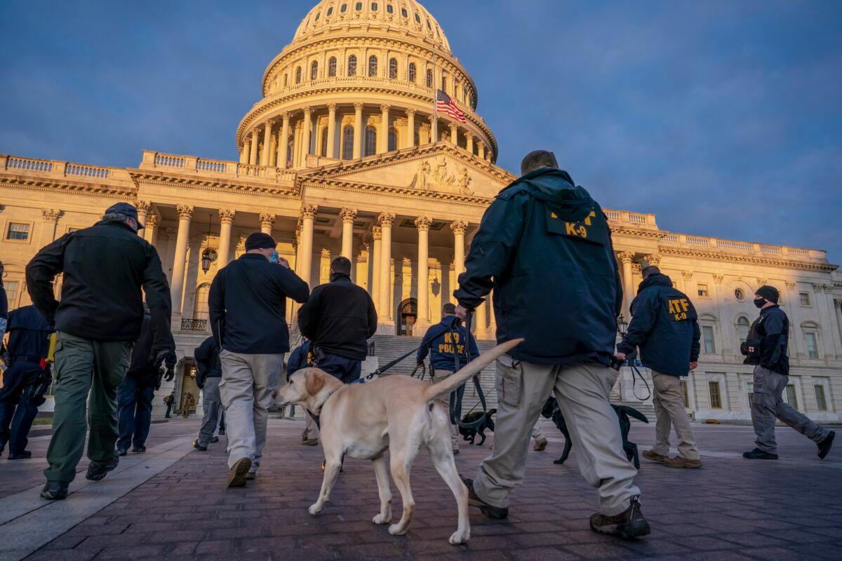 Federal K-9 units prepare for a security sweep in preparation for the inauguration ceremonies on Capitol Hill in Washington, Tuesday, Jan. 19, 2021. President-elect Joe Biden will be sworn in as the 46th president on Wednesday. (AP Photo/J. Scott Applewhite)