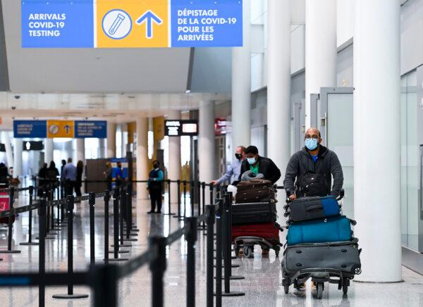 Travellers arrive at the Toronto Pearson International Airport in Toronto on Feb. 1, 2021. (Nathan Denette/The Canadian Press)