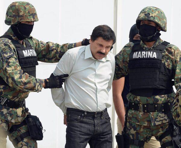 Mexican drug trafficker Joaquin Guzmán Loera, aka "El Chapo" (C), is escorted by marines as he is presented to the press in Mexico City, on Feb. 22, 2014. (Alfredo Estrella /AFP via Getty Images)