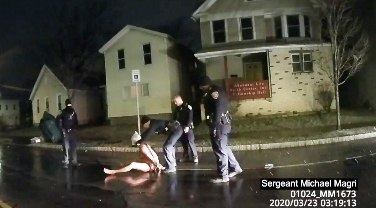 In this file image taken from police body camera video, a Rochester police officer puts a hood over the head of Daniel Prude, in Rochester, N.Y., on March 23, 2020. (Rochester Police via Roth and Roth LLP via AP, File)