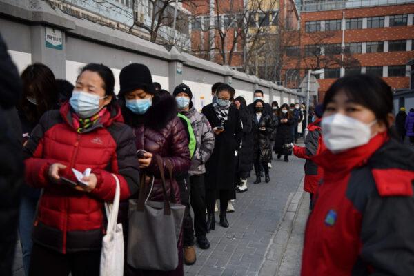 People line up to be tested for COVID-19 in Beijing on Jan. 22, 2021, part of a drive to test two million people in 48 hours as the city rushes to snuff out a new local cluster of cases believed to be linked to a more contagious virus variant. (Greg Baker/AFP via Getty Images)