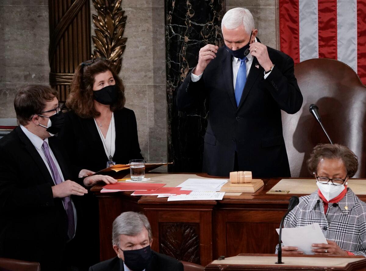 Senate Parliamentarian Elizabeth MacDonough, left, works beside Vice President Mike Pence during the certification of Electoral College ballots in the presidential election, in the House chamber at the Capitol in Washington on Jan. 6, 2021. (J. Scott Applewhite/AP Photo)