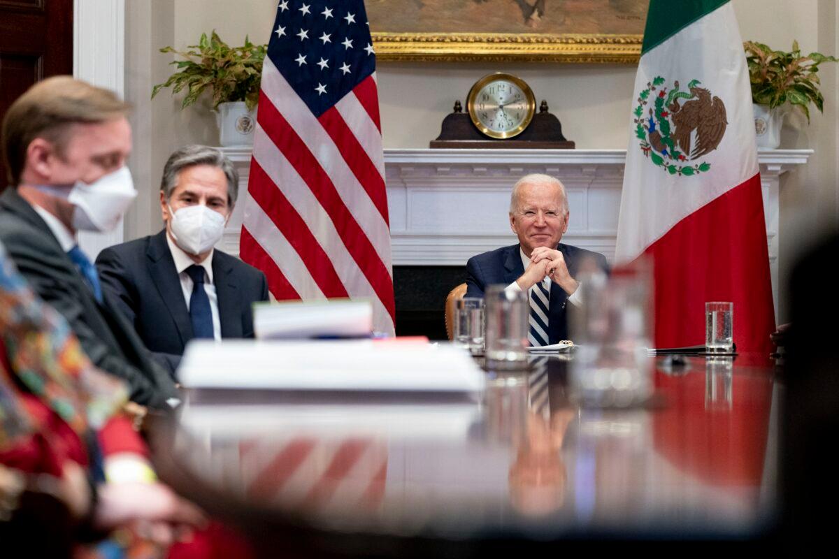 President Joe Biden, accompanied by White House national security adviser Jake Sullivan, left, and Secretary of State Antony Blinken, second from left, attends a virtual meeting with Mexican President Andres Manuel Lopez Obrador, in the Roosevelt Room of the White House in Washington on March 1, 2021. (Andrew Harnik/AP Photo)