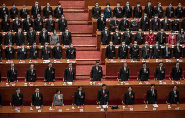 Chinese leader Xi Jinping (second row C) and lawmakers stand for the anthem during the closing session of the rubber-stamp legislature’s conference at the Great Hall of the People in Beijing, China, on March 11, 2021. (Kevin Frayer/Getty Images)