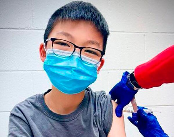 Caleb Chung receives the first dose of Pfizer coronavirus vaccine or placebo as a trial participant for kids ages 12-15, at Duke University Health System in Durham, N.C., on Dec. 22, 2020. (Richard Chung via AP)