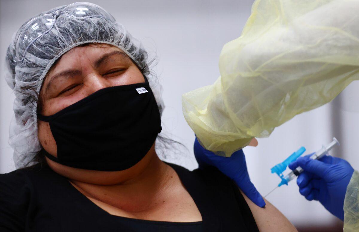 Eloina Galvez receives a one-shot dose of the Johnson & Johnson COVID-19 vaccine at a clinic geared toward agriculture workers in Riverside, Calif., on April 5, 2021. (Mario Tama/Getty Images)