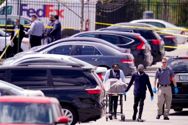 A body is taken from the scene where multiple people were shot at a FedEx Ground facility in Indianapolis, on April 16, 2021. (Michael Conroy/AP Photo)