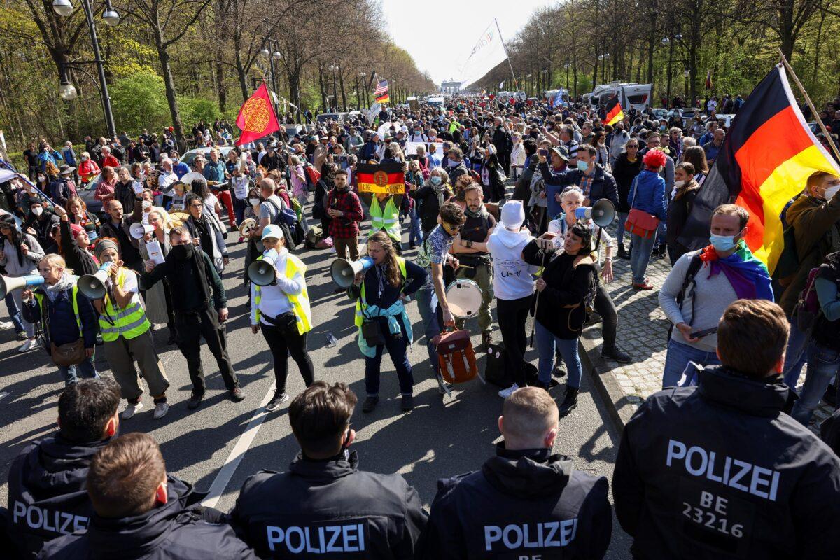 Members of the police stand guard as people protest against the government measures to curb the spread of the coronavirus disease (COVID-19), as the lower house of parliament Bundestag discusses additions for the Infection Protection Act, in Berlin, Germany, on April 21, 2021. (Christian Mang/Reuters)