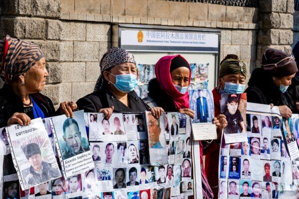 A group of female protestors demand safe passage home for their relatives, who are missing, jailed or trapped in China’s Xinjiang region outside the Chinese consulate in Almaty, Kazakhstan, on March 9, 2021. (Abduaziz Madyrovi/AFP via Getty Images)