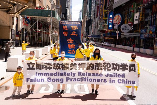 Practitioners of the spiritual discipline Falun Gong hold a parade in New York to celebrate World Falun Dafa Day, and to protest the ongoing persecution of the group by the Chinese Communist Party in China, on May 13, 2020. (Larry Dai/The Epoch Times)