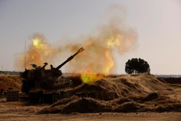 An Israeli mobile artillery unit fires near the border between Israel and the Gaza Strip, May 12, 2021. (Amir Cohen/Reuters)