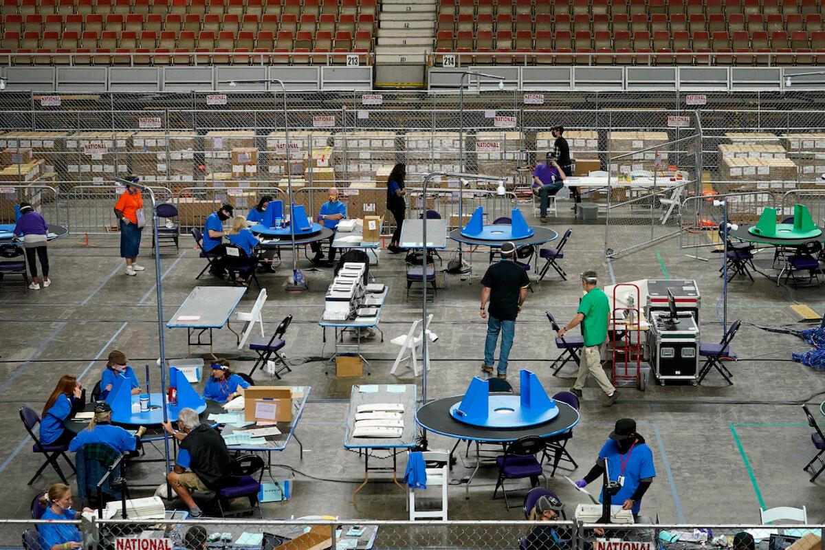 Maricopa County ballots cast in the 2020 general election are examined and recounted by contractors working for Florida-based company Cyber Ninjas, at Veterans Memorial Coliseum in Phoenix, Arizona, on May 6, 2021. (Matt York/Pool/AP Photo)