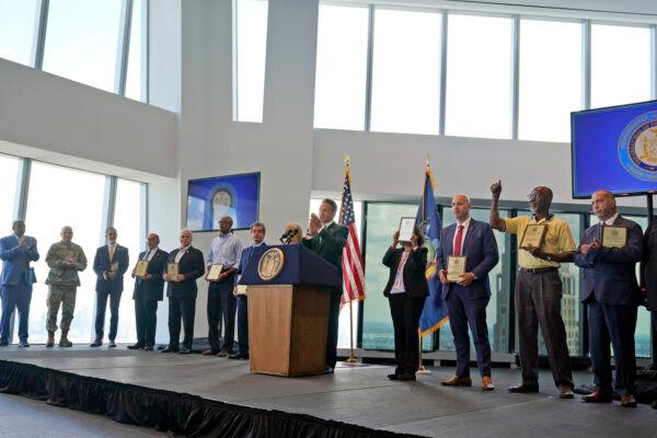 New York Gov. Andrew Cuomo, center, applauds with others as representatives for various essential jobs receive plaques to recognize their work during the pandemic during a news conference at One World Trade in New York, Tuesday, June 15, 2021. (Seth Wenig/AP Photo)