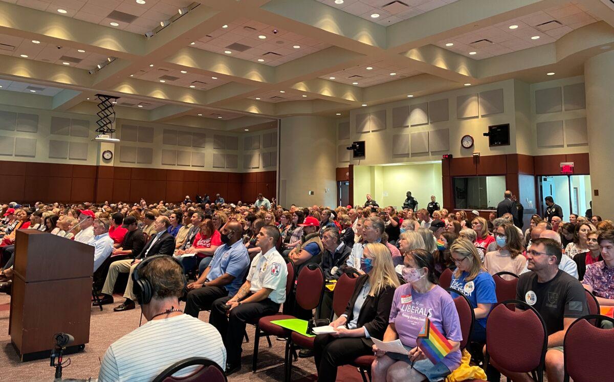 Attendees are seen during a school board meeting in Loudoun County, Va., on June 22, 2021. (Terri Wu/The Epoch Times)