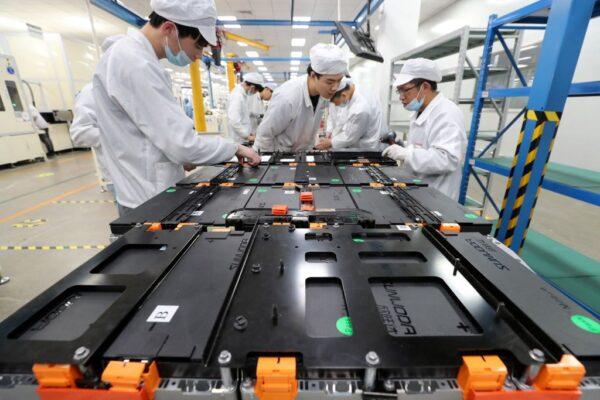 Workers at a factory for Xinwangda Electric Vehicle Battery Co. Ltd, which makes lithium batteries for electric cars and other uses, in Nanjing in China's eastern Jiangsu Province, on March 12, 2021. (STR/AFP via Getty Images)