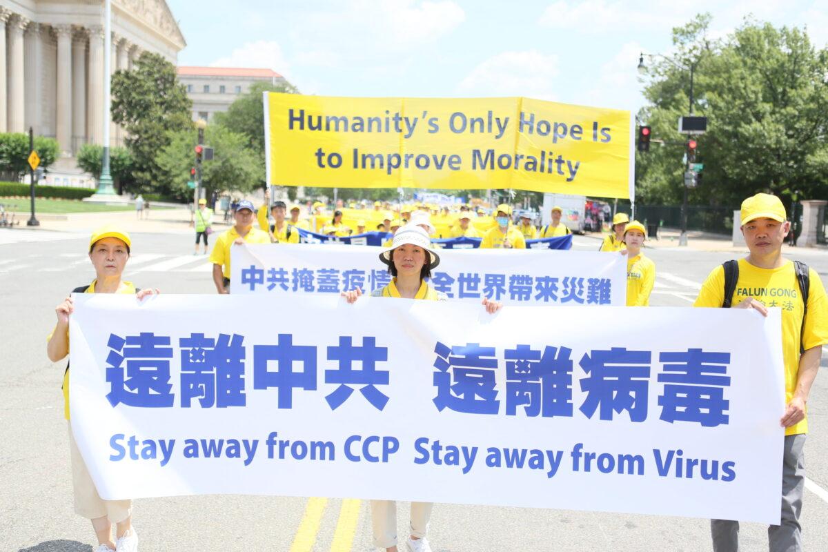 Falun Dafa practitioners take part in a parade marking the 22nd anniversary of the start of the Chinese regime’s persecution of Falun Dafa, in Washington on July 16, 2021. (Lisa Fan/The Epoch Times)