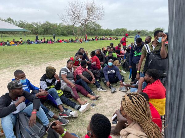A group of more than 350 illegal immigrants wait for Border Patrol after crossing the Rio Grande from Mexico into Del Rio, Texas, on July 25, 2021. (Charlotte Cuthbertson/The Epoch Times)