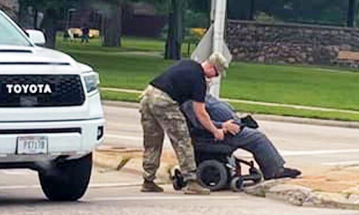 Touching Photo Shows Soldier Helping Man Struggling in Wheelchair Cross Busy Street—And It Goes Viral