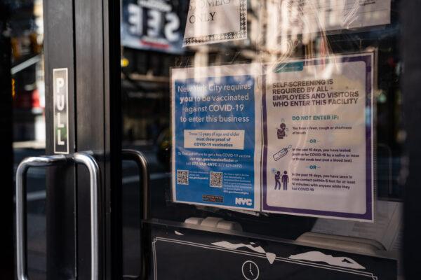 Vaccine proof requirement note displays at a restaurant store front in New York on Sept. 7, 2021. (Chung I Ho/The Epoch Times)